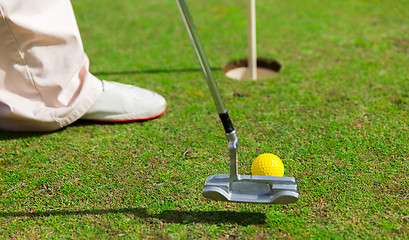 Image showing close up of man with club and ball playing golf