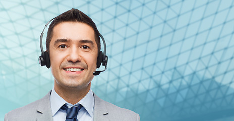 Image showing happy businessman in headset over grid background