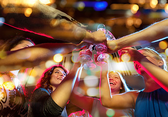 Image showing smiling friends with glasses of champagne in club