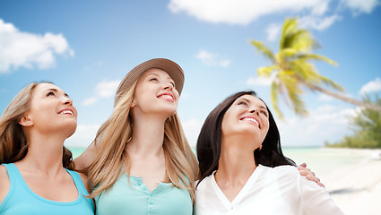 Image showing group of happy young women over summer beach