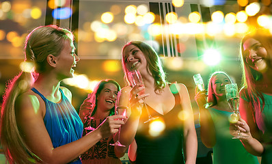 Image showing young women with glasses of champagne in club