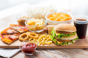 Image showing close up of fast food snacks and drink on table