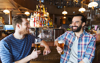 Image showing happy male friends drinking beer at bar or pub