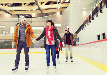 Image showing happy friends on skating rink