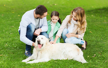 Image showing happy family with labrador retriever dog in park