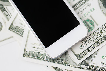 Image showing close up of smartphone and dollar money