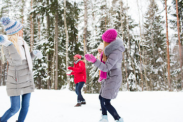 Image showing happy friends playing snowball in winter forest