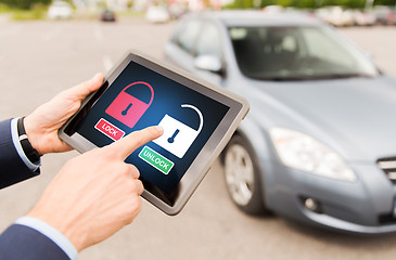 Image showing close up of hands with lock icons on tablet pc