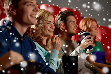 Image showing happy friends with popcorn and drinks in cinema