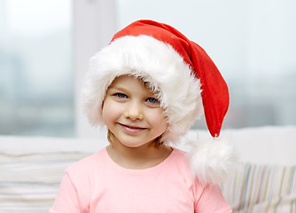 Image showing smiling little girl in santa hat at home