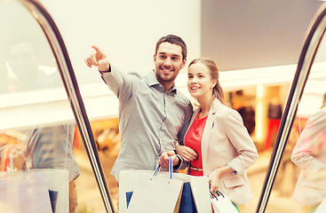 Image showing happy young couple with shopping bags in mall