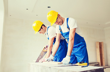 Image showing group of builders with tools indoors