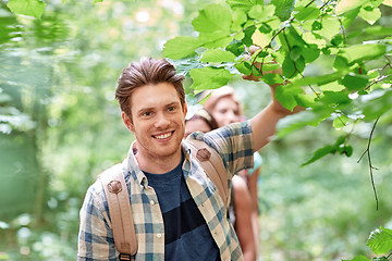 Image showing group of smiling friends with backpacks hiking