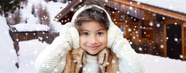 Image showing happy little girl wearing earmuffs