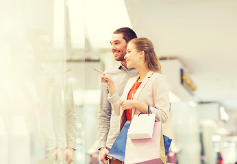 Image showing happy young couple with shopping bags in mall