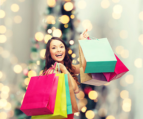 Image showing smiling woman with colorful shopping bags