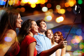 Image showing friends with smartphone taking selfie in club