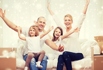 Image showing smiling parents and two little girls at new home