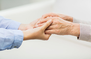 Image showing close up of senior and young woman hands