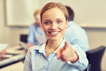Image showing smiling businesswoman pointing finger on you