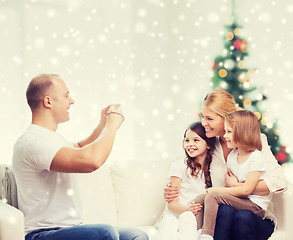 Image showing happy family with camera at home