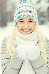 Image showing smiling young woman in winter forest