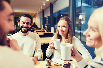 Image showing happy friends meeting and drinking tea or coffee