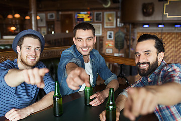 Image showing happy male friends drinking beer at bar or pub