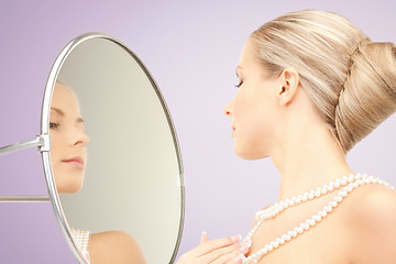 Image showing beautiful woman with pearl necklace and mirror