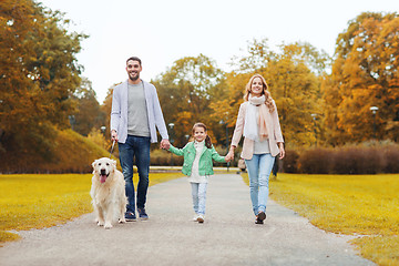 Image showing happy family with labrador retriever dog in park