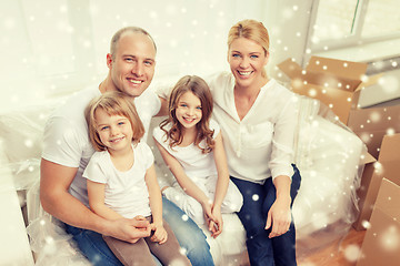 Image showing smiling parents and two little girls at new home