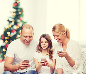 Image showing happy family with smartphones