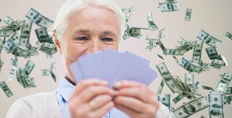 Image showing close up of happy senior woman playing cards