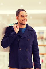 Image showing happy young man with shopping bags in mall