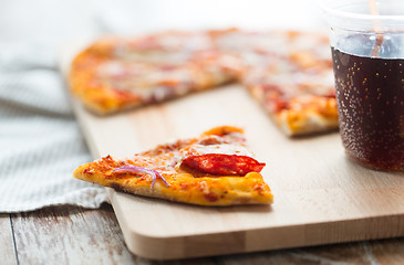 Image showing close up of pizza with carbonated drink on table