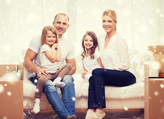 Image showing smiling parents and two little girls at new home