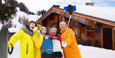 Image showing happy friends with snowboards and smartphone