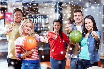 Image showing happy friends in bowling club showing thumbs up