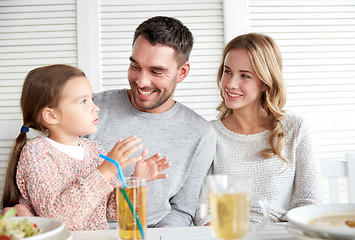 Image showing happy family having dinner at restaurant or cafe