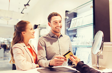 Image showing happy couple choosing engagement ring in mall