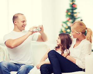 Image showing happy family with camera at home