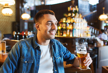 Image showing happy man drinking beer at bar or pub