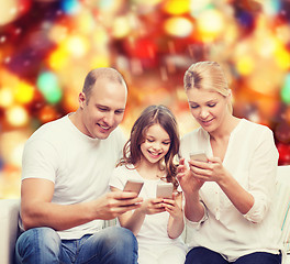 Image showing happy family with smartphones