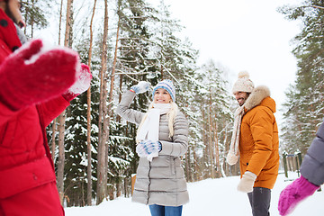 Image showing happy friends playing snowball in winter forest