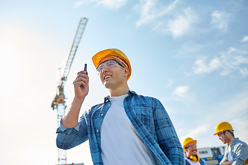 Image showing builder in hardhat with walkie talkie