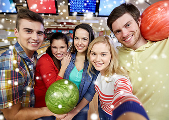 Image showing happy friends taking selfie in bowling club