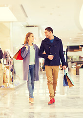 Image showing happy young couple with shopping bags in mall