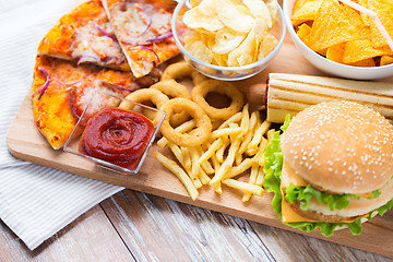 Image showing close up of fast food snacks on wooden table