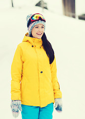 Image showing happy young woman in ski goggles outdoors