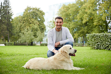 Image showing happy man with labrador dog walking in city